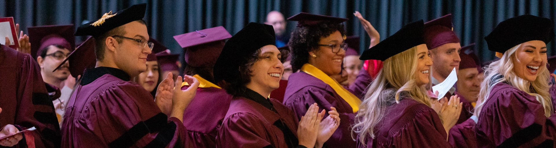 JD and MLS students clapping during the ASU Law convocation ceremony.