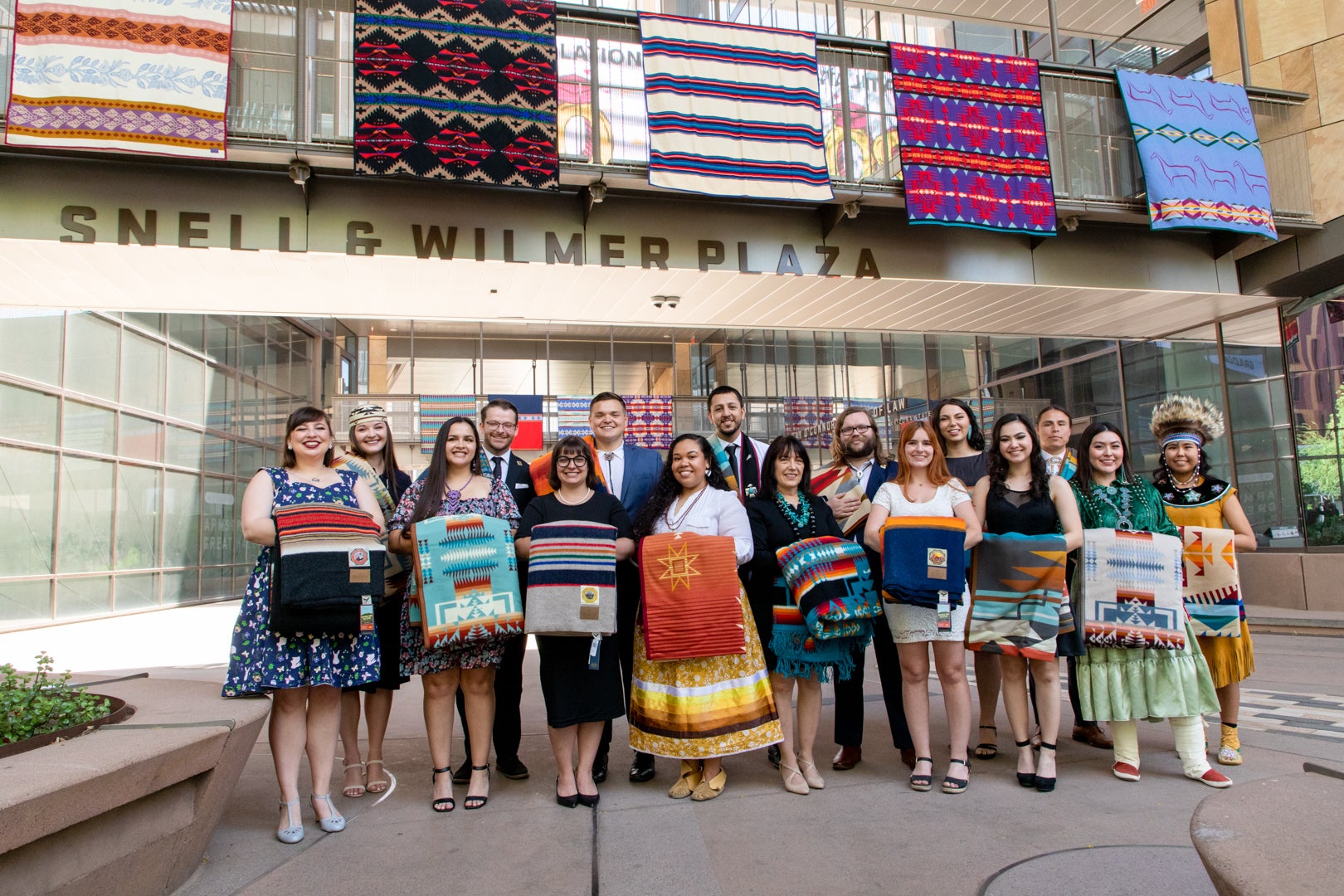Indian Legal JD graduates standing in front of Beus Center for Law and Society decorated in their ceremonial blankets
