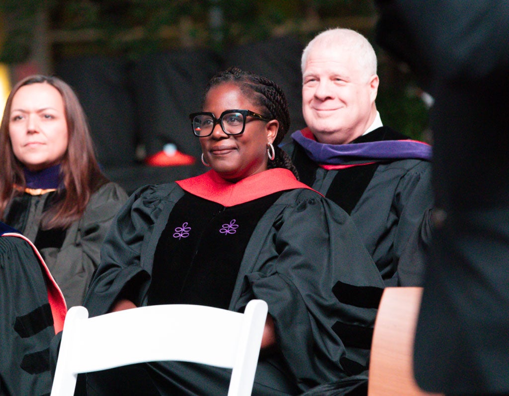 Professor Angela Banks sitting in black regalia at the Fall 2022 Convocation ceremony.