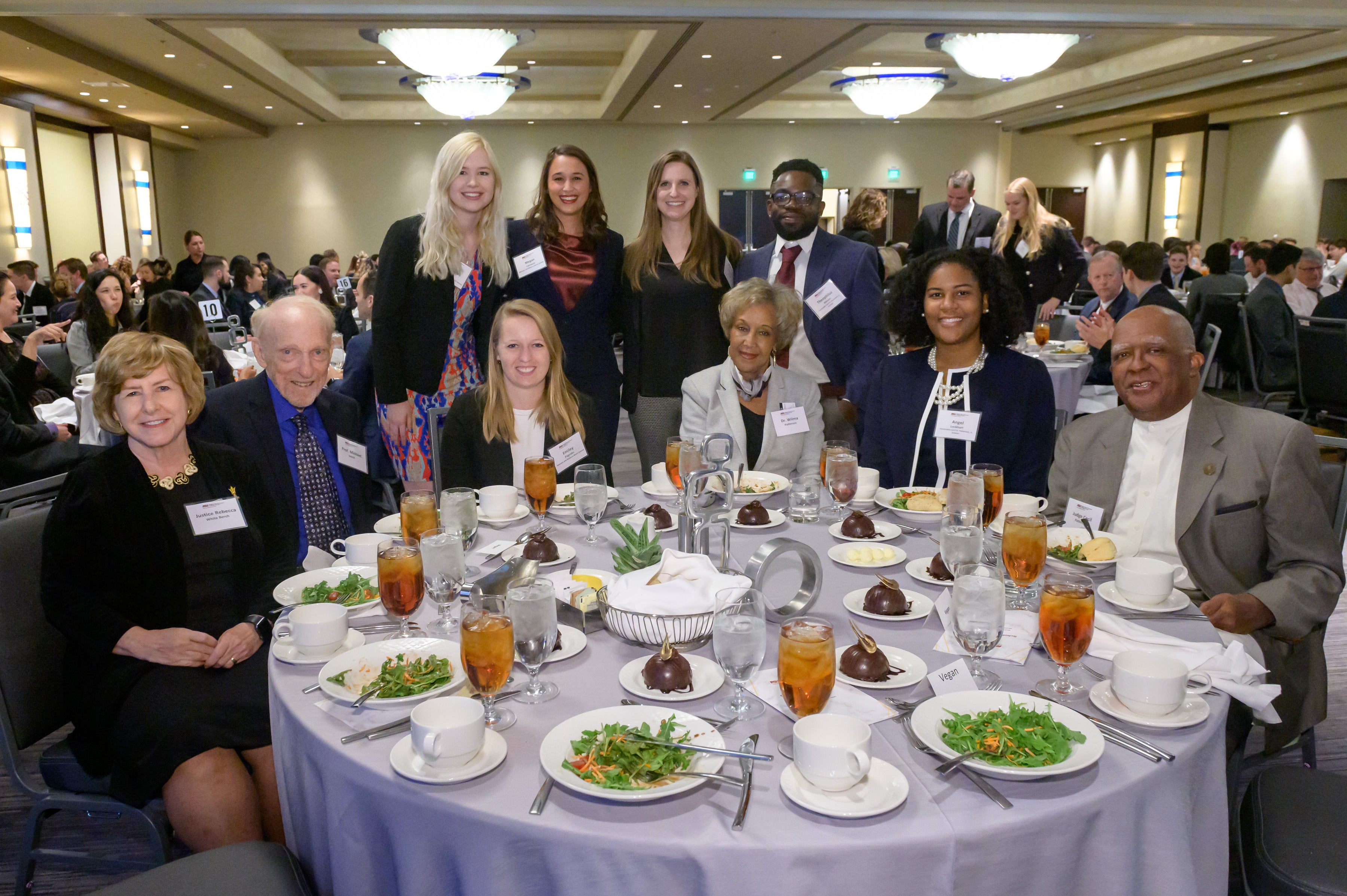 Notable ASU Law Alumni, students, and important ASU Law figures sitting at a table during the Scholarship Luncheon.