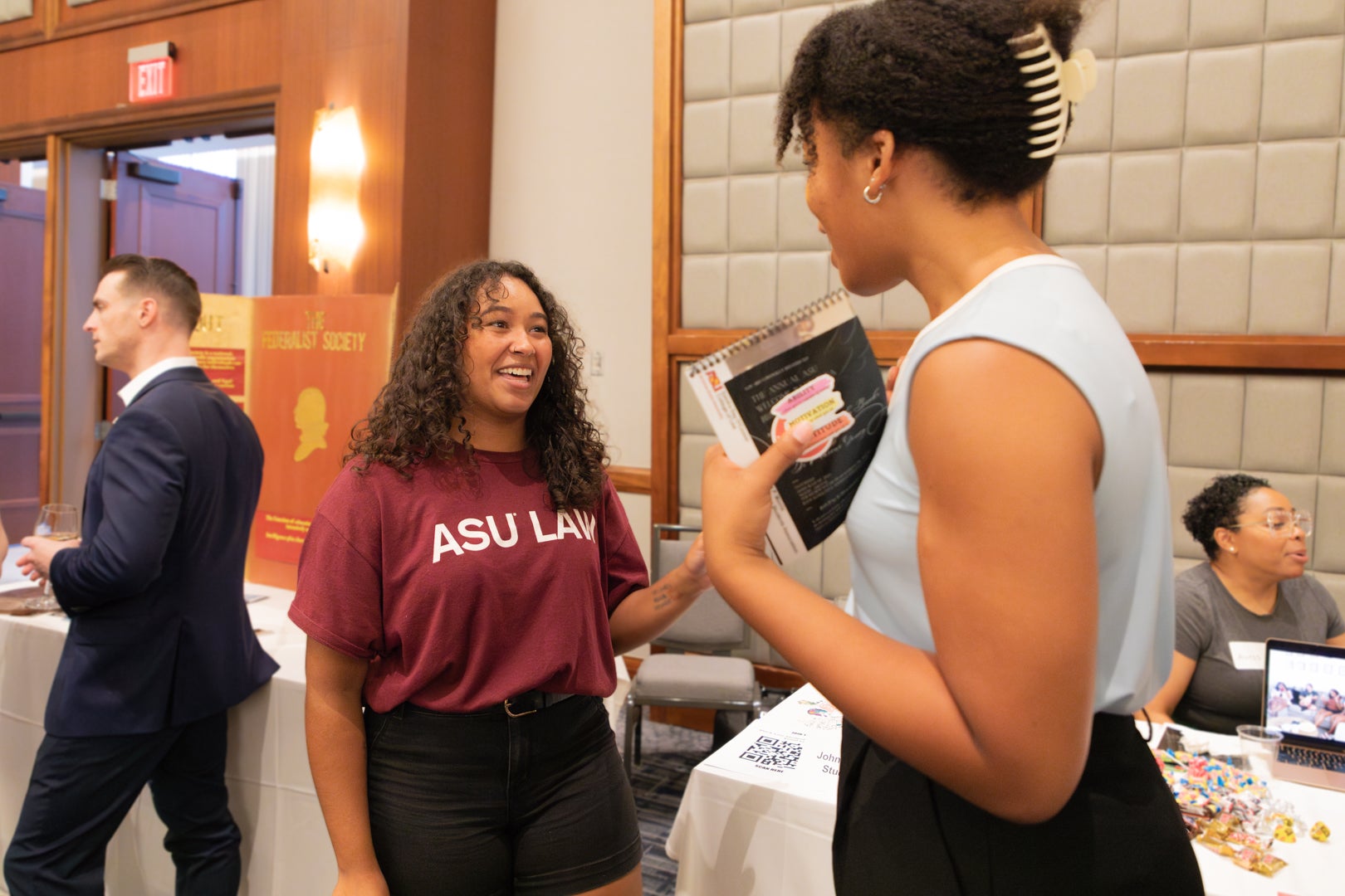 Two ASU Law students talking to each other during the student organization fair.