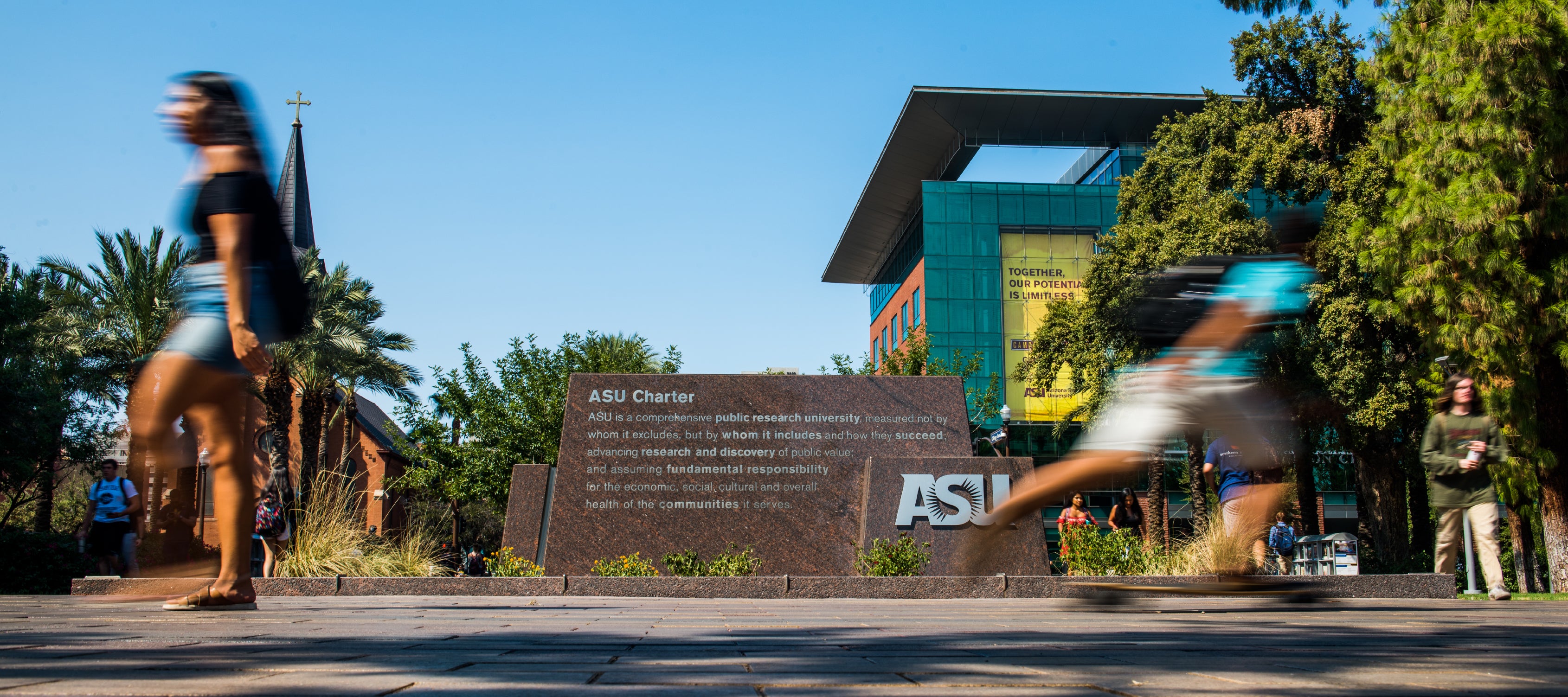 Students walking in front of the ASU charter on ASU Tempe campus.