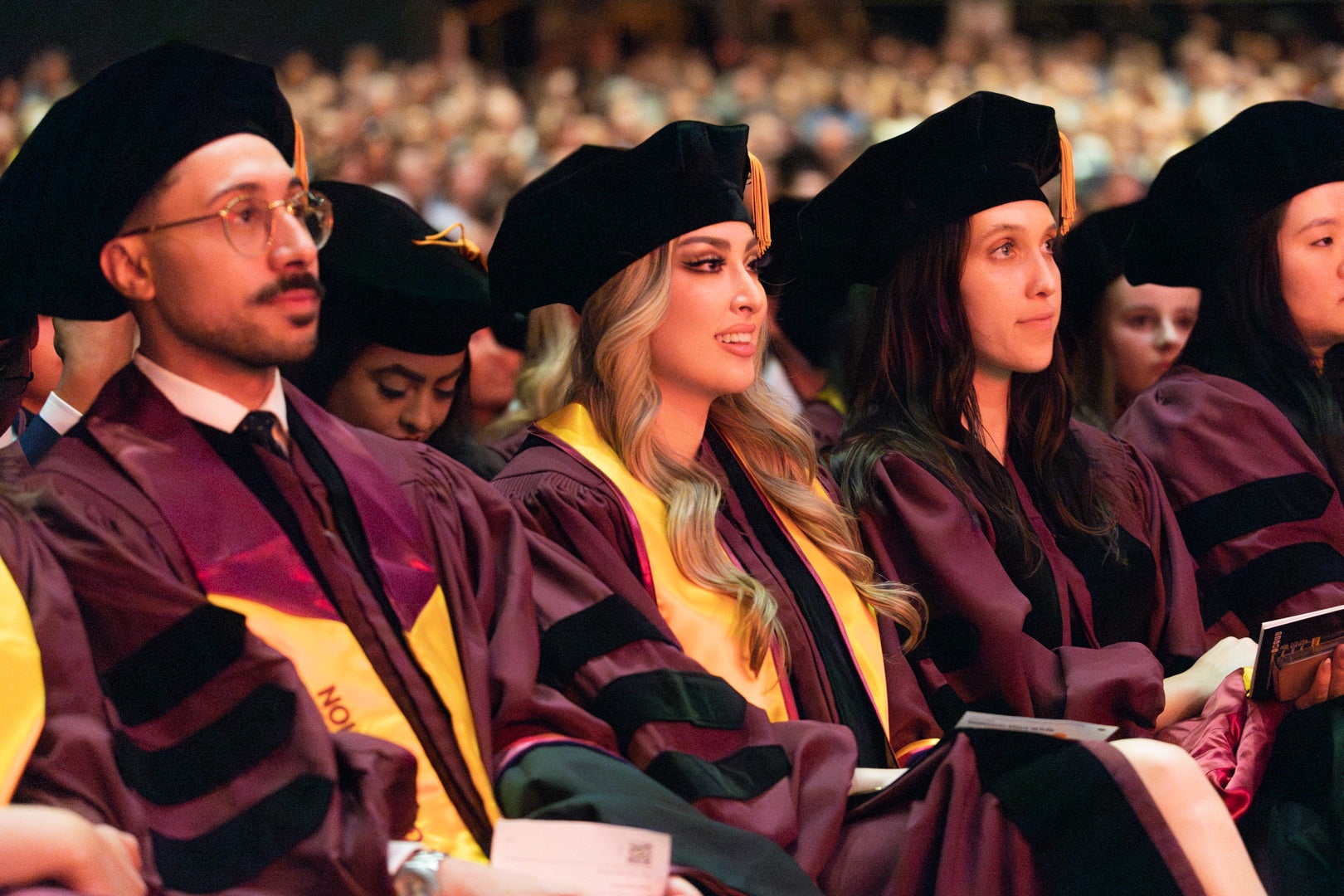 Three JD graduate students dressed in regalia during the during the Spring 2024 Convocation ceremony.