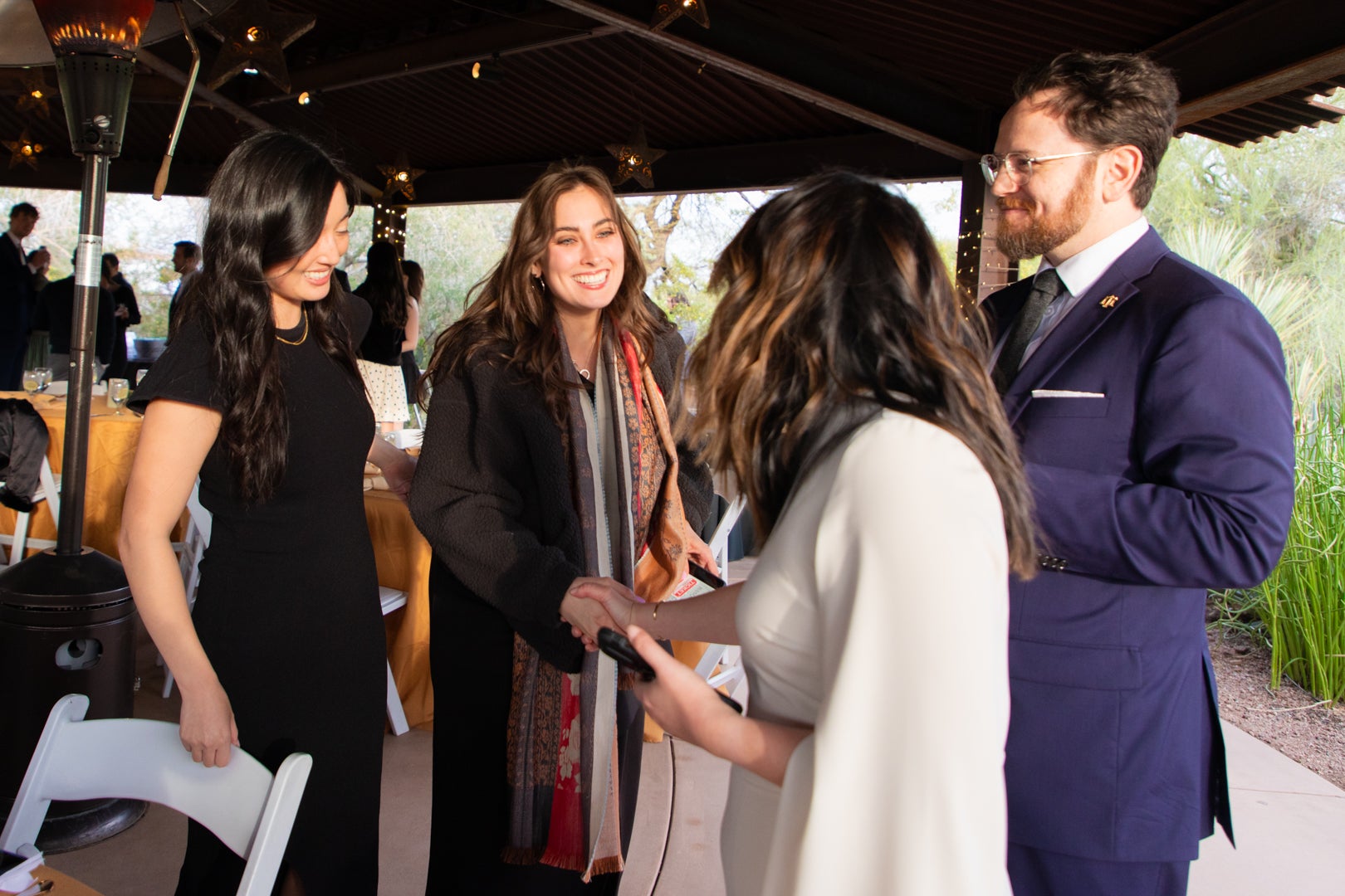 ASU Law students laughing and shaking hands with each other.