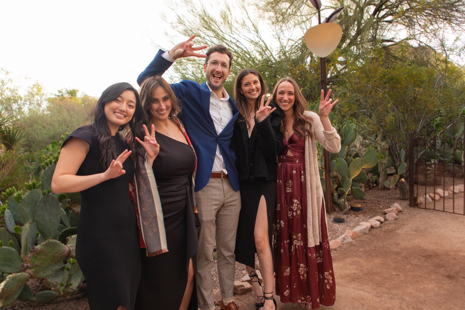 ASU Law students holding up the pitchfork at an ASU sustainability event surrounded by cacti.