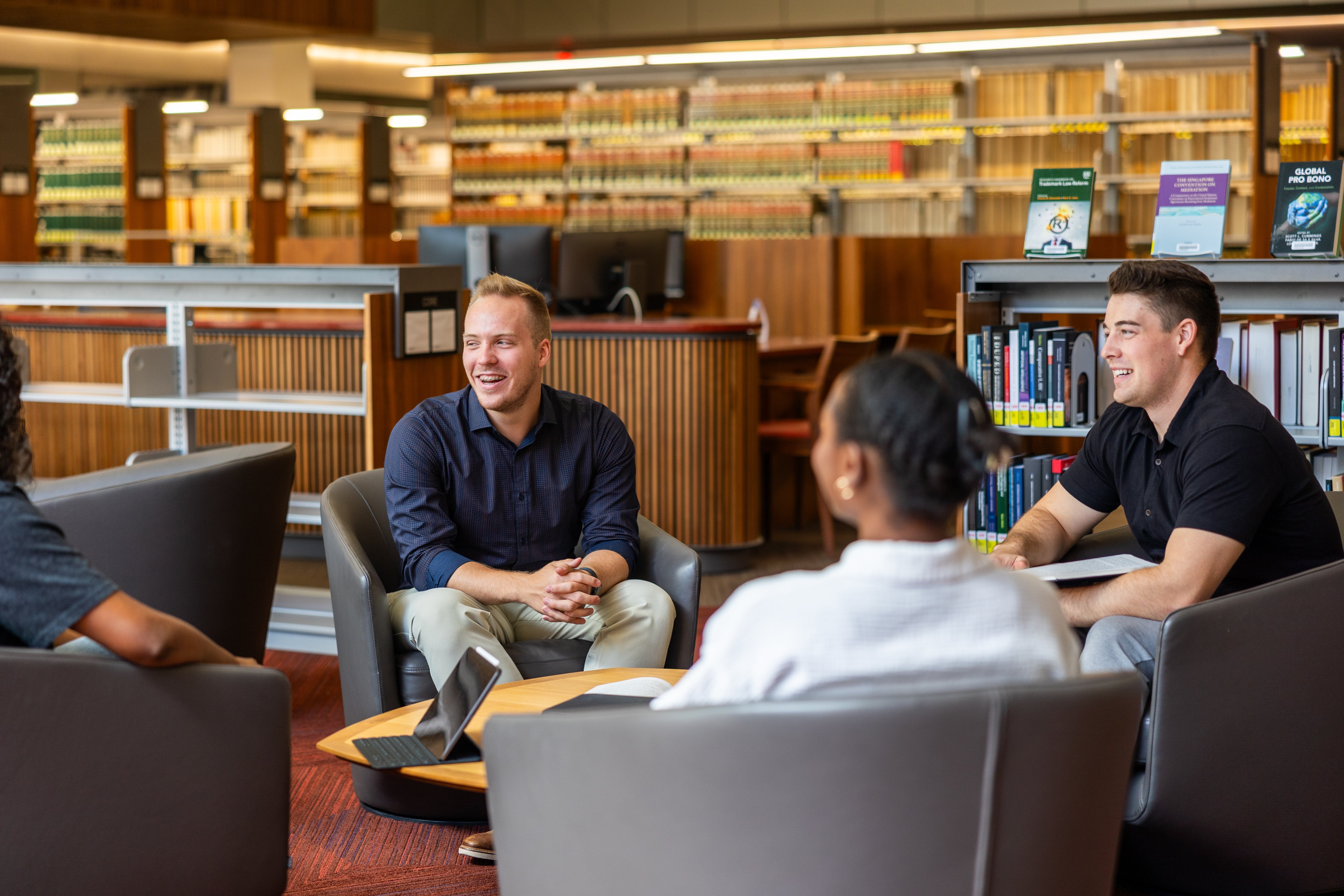 Students seated, chatting in a library