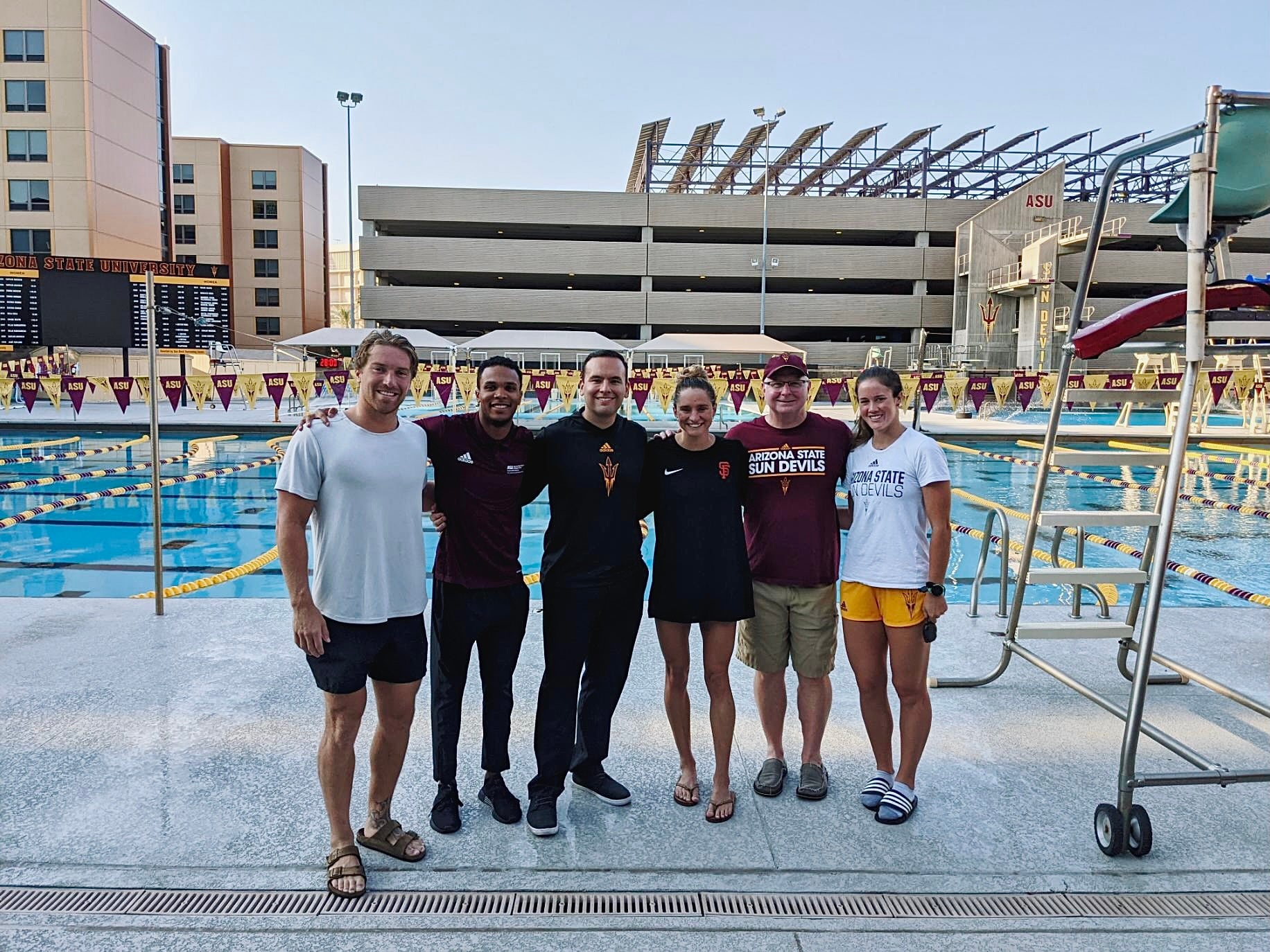 A handful of ASU Sports Law and Business students standing in front of the ASU student pool.