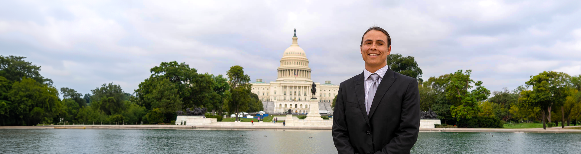 ASU Law student dressed in a suit standing in front of the United State Capital building.