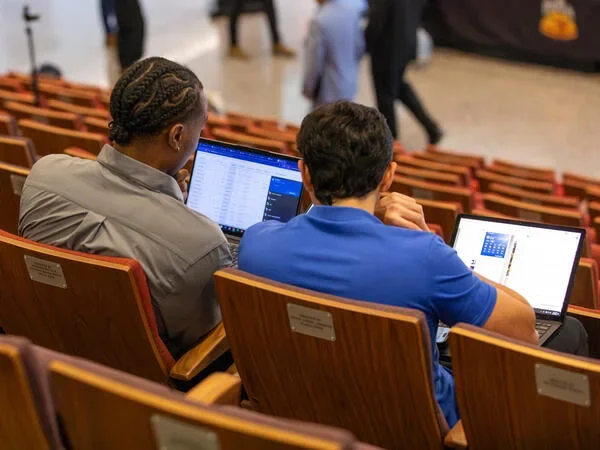 two students on a laptop