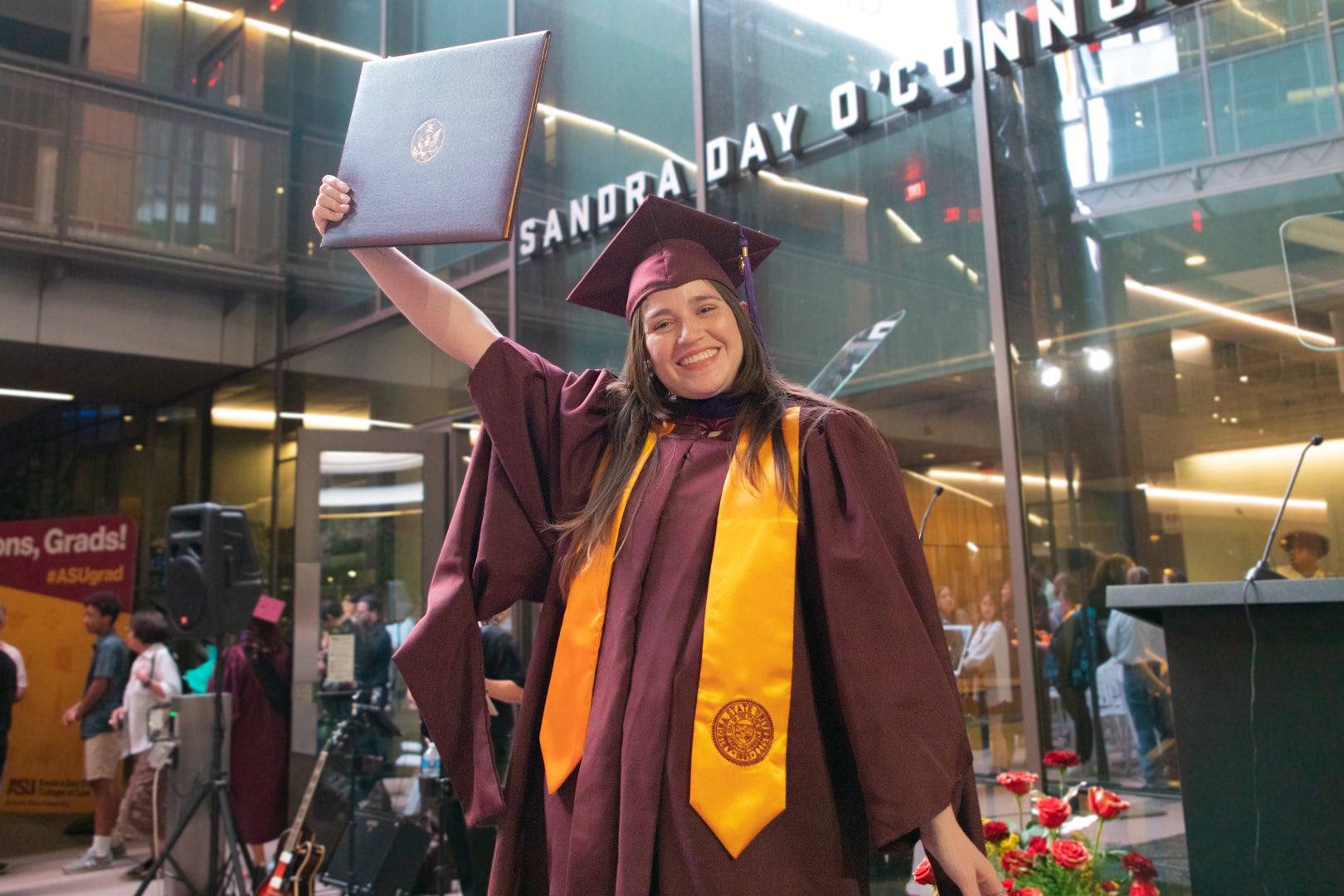 Student holding up a law degree