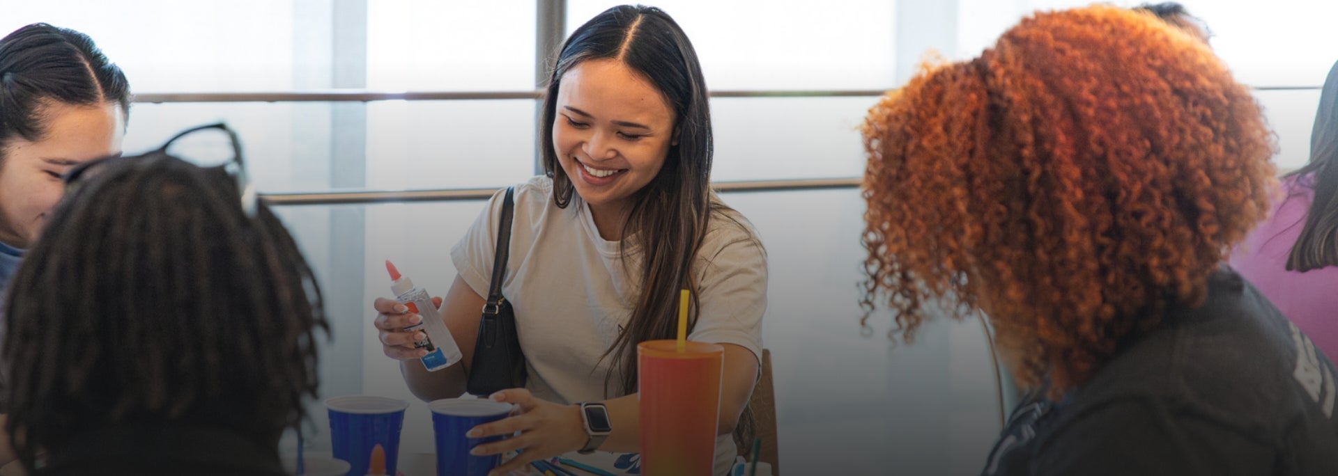 A student smiles while unwinding at an arts and crafts event hosted at ASU Law.