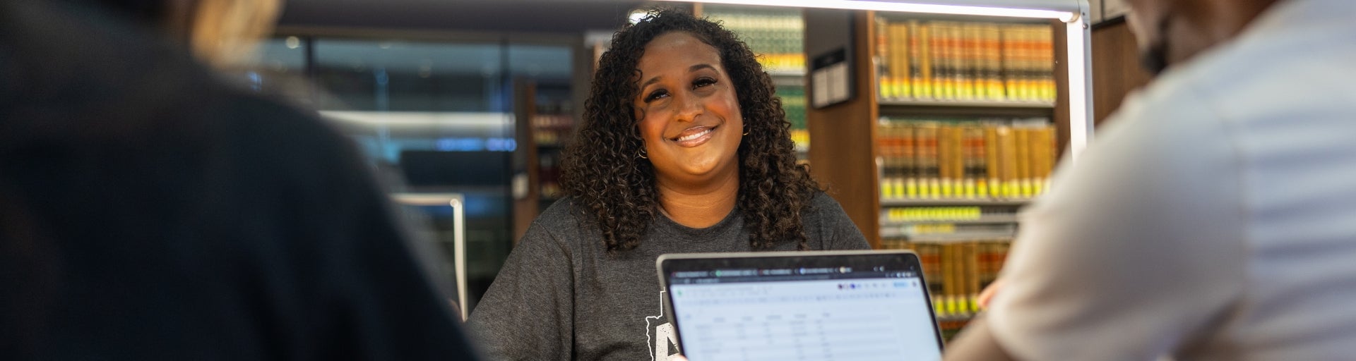 A student smiles while studying in the ASU Law Library