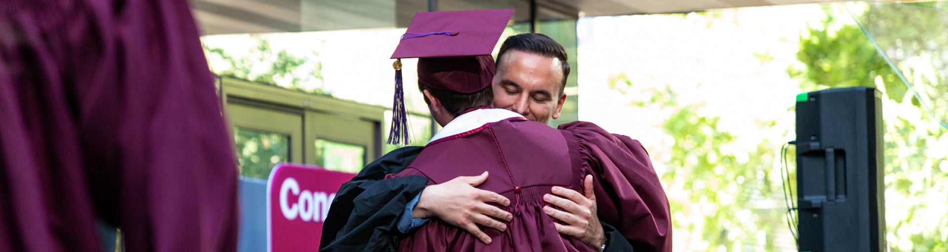 Aaron Hernandez, Executive Director of Allan Bud Selig Sports Law and Business Program, embraces an MSLB graduate at the Spring 2025 MSLB Convocation ceremony