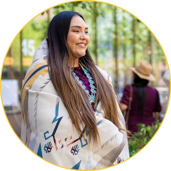An ASU Law student smiles while attending the Indian Legal Program Blanket Ceremony for graduates