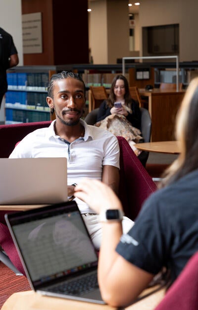 Students chat while studying in the ASU Law library