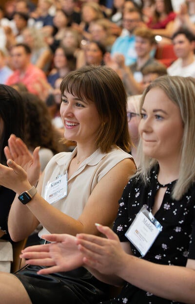 Student applaud while attending orientation