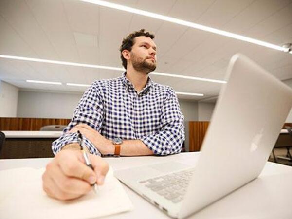 JD Admission Student in class with a laptop on the desk
