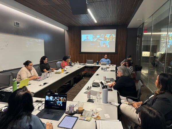 The American Indian Policy Institute advisory board meets in a conference room.