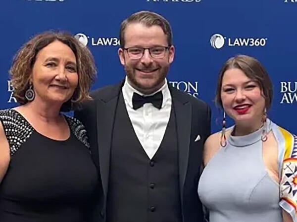 Stacy Leeds, Noah Goldenberg and guest pose for a photo.