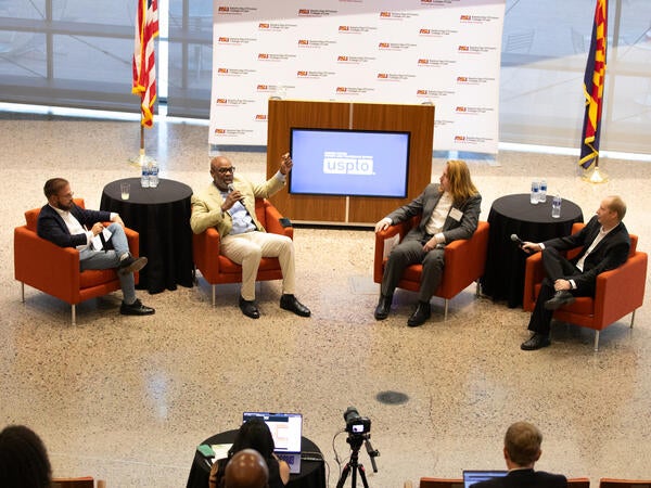 four people sitting on chairs