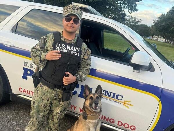 man in military uniform with dog