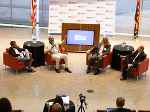four people sitting on chairs