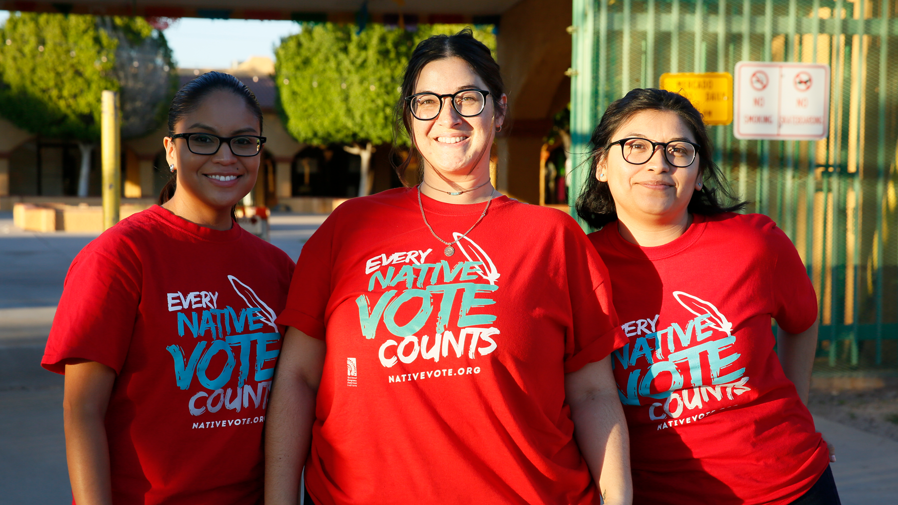 Three students wearing Native Vote T-shirts