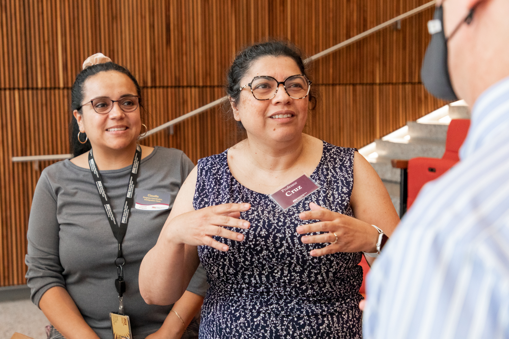 Immigration Clinic director, Evelyn Cruz talking with a student during an information fair.