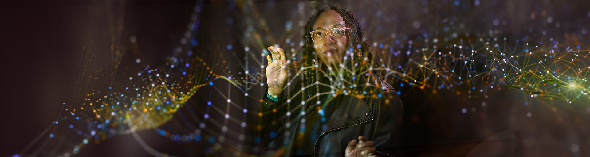 Woman wearing glasses, holding up her finger playing with animated lines in the air.