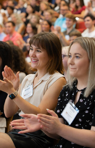 Student applaud while attending orientation